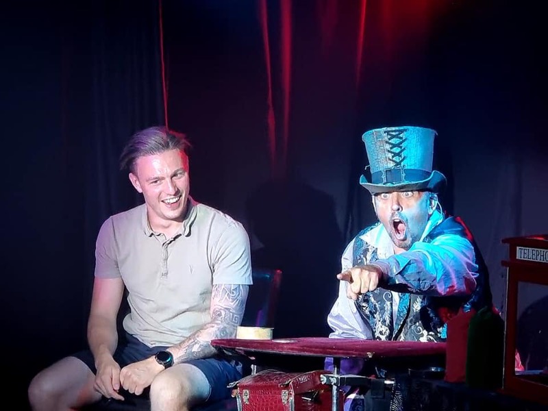 A guest laughing as the magician reacts in amazement